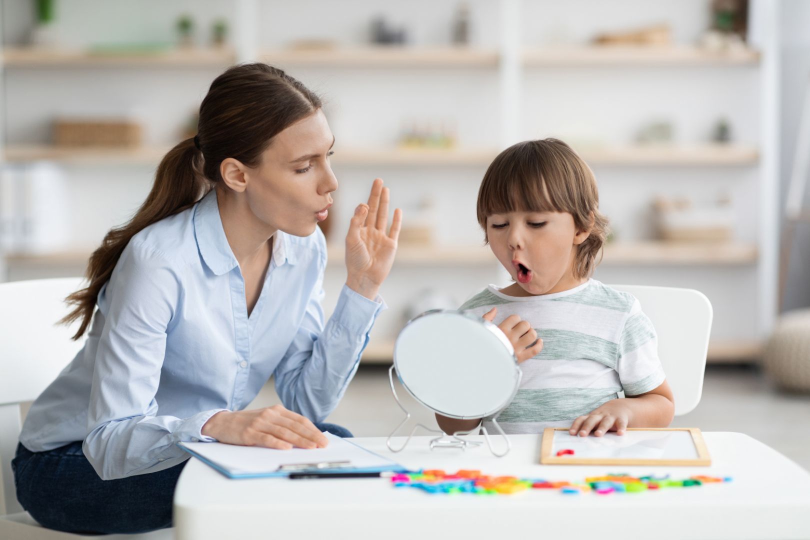 cute-little-boy-pronouncing-sound-o-looking-mirror-professional-woman-therapist-teaching-kid