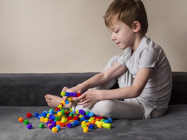 little-boy-playing-with-colorful-game-sofa